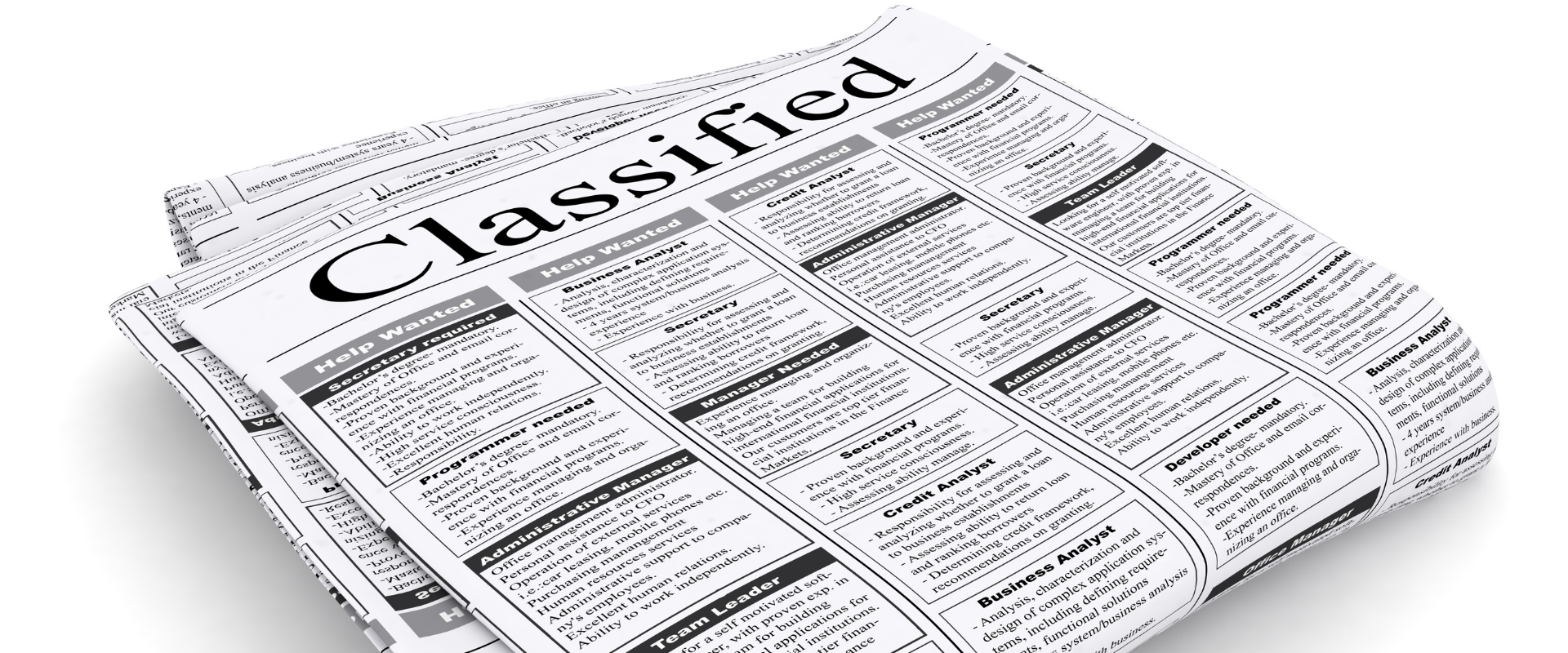 Rolled newspaper open to the classifieds section with a bold 'Classified' heading at the top side.