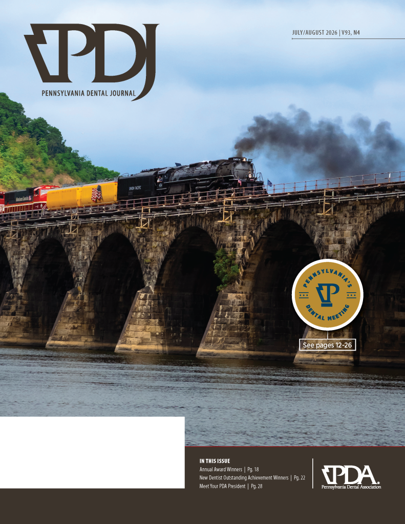 Train crossing a stone arch bridge on a blue-sky landscape, with a large 'Pennsylvania Dental Journal' logo in the top left and a circular 'See pages 12–26' badge on the right.